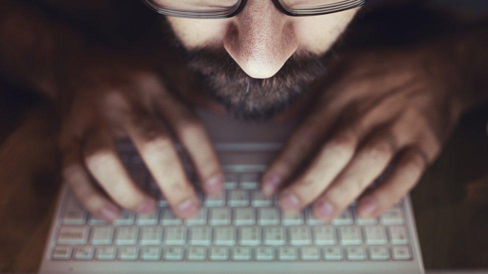 Bearded man using a laptop