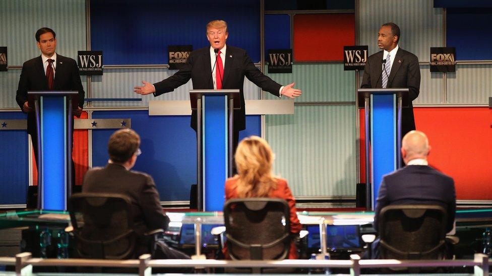 Presidential candidate Donald Trump (C) speaks while Sen. Marco Rubio (L) (R-FL), and Ben Carson look on during the Republican Presidential Debate sponsored by Fox Business and the Wall Street Journal at the Milwaukee Theatre November 10, 2015 in Milwaukee,