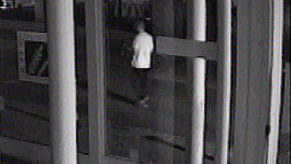 A CCTV photo of a man in a white T-shirt and dark bottoms, with short hair, at 3.21am in Cornhill Walk