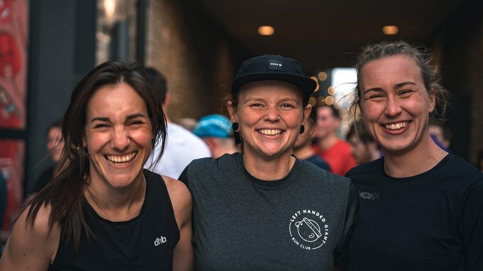 Jay Medway smiling standing with two other smiling women