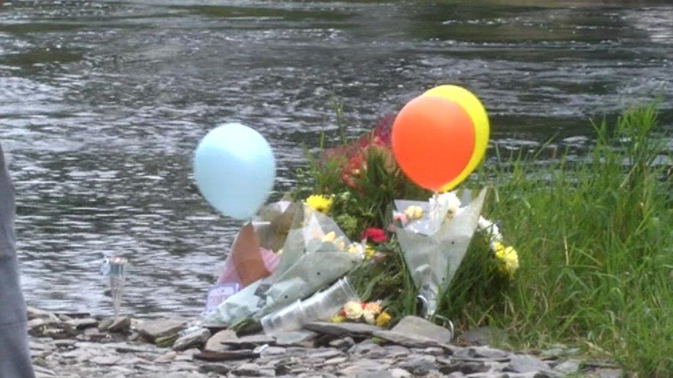 Balloons and flowers were left at the river bank in Newcastle Emlyn