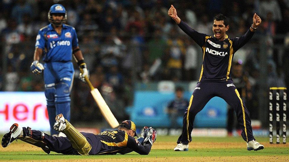 Kolkata Knight Riders cricketer Sunil Narine (R) celebrates as teammate Brendon McCullum dives to take a catch of unseen Mumbai Indians batsman Rohit Sharma during the IPL Twenty20 cricket match between Mumbai Indians and Kolkata Knight Riders at The Wankhede Stadium in Mumbai on May 16, 2012.