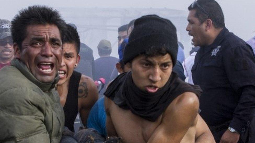 Severely burnt victims are taken away from the smouldering ruins of the fireworks market (21 December 2016)