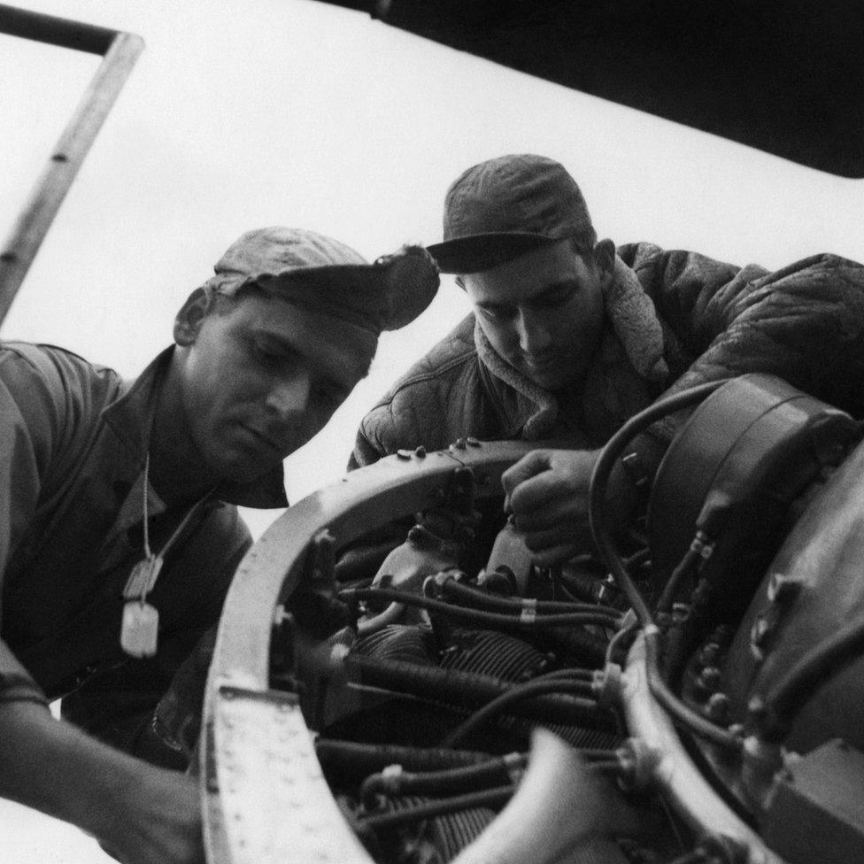 Technical Sergeant Lester Reifeiss (left) and Sergeant Jasper 'J D' Taylor of the 78th Fighter Group repair a P-47 Thunderbolt at Duxford, Cambridgeshire.