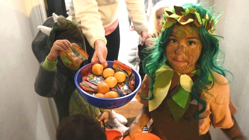 Children going trick-or-treating in London.