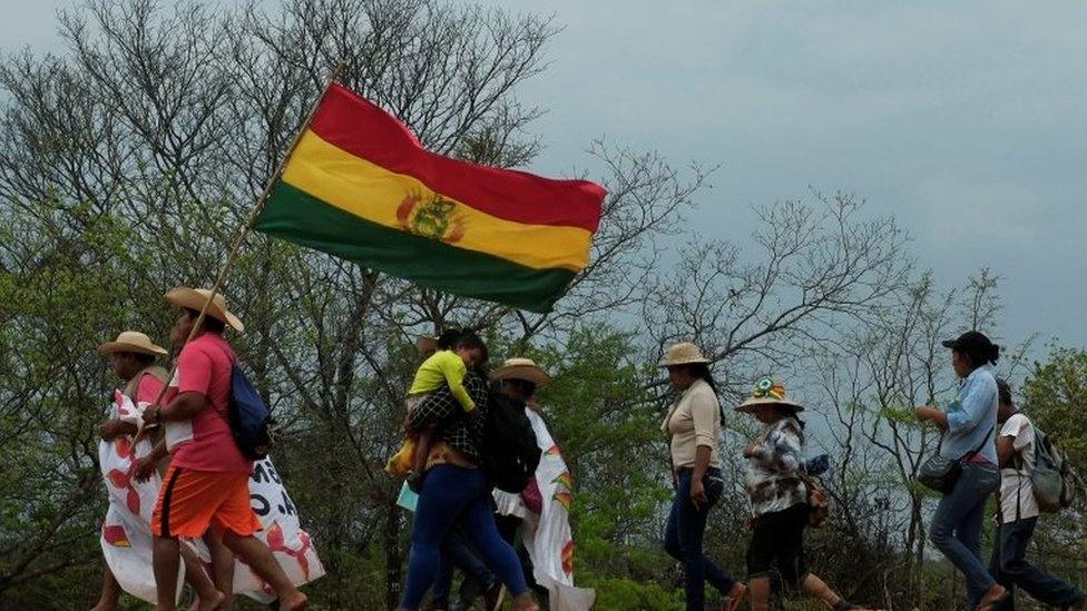 Protesters, including women and children, are marching from San Ignacio to Santa Cruz de la Sierra