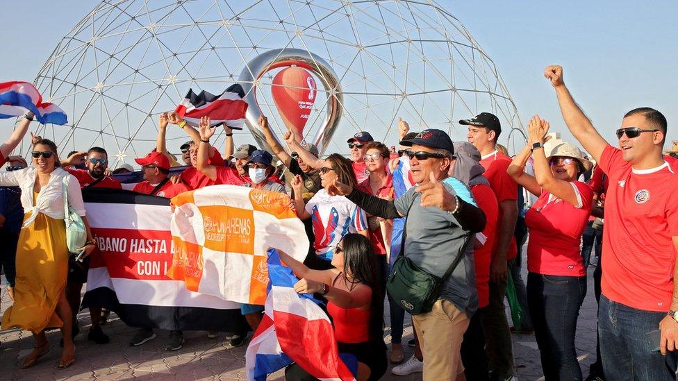 Fans taking photos in front of the World Cup countdown clock