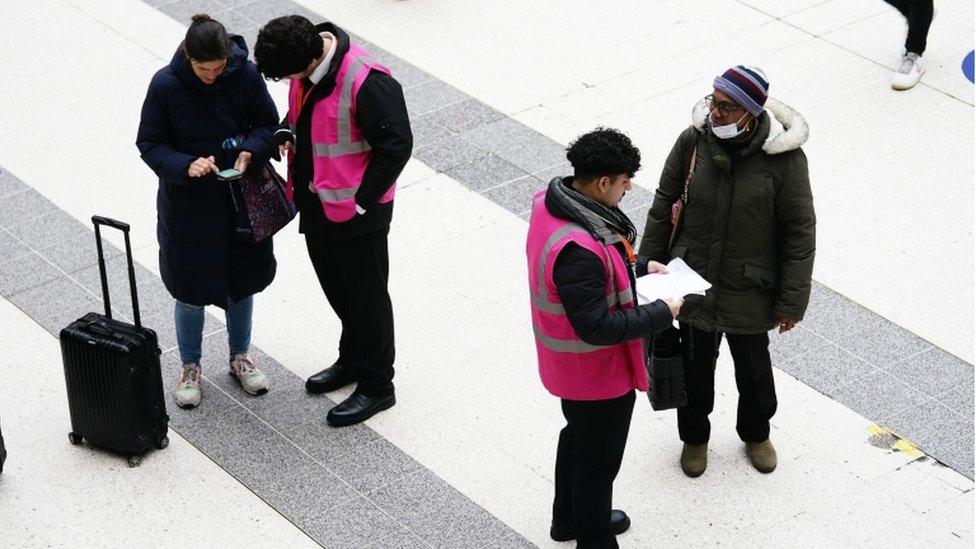 Staff at Liverpool Street station in central London help travellers during a strike by members of the Rail, Maritime and Transport union (RMT).