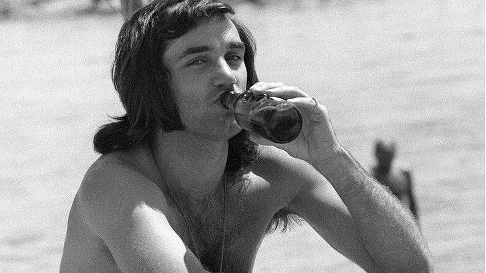 George Best relaxing on a beach in Spain in 1972