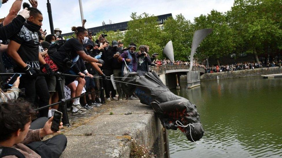 Colston statue lowered into Bristol harbour