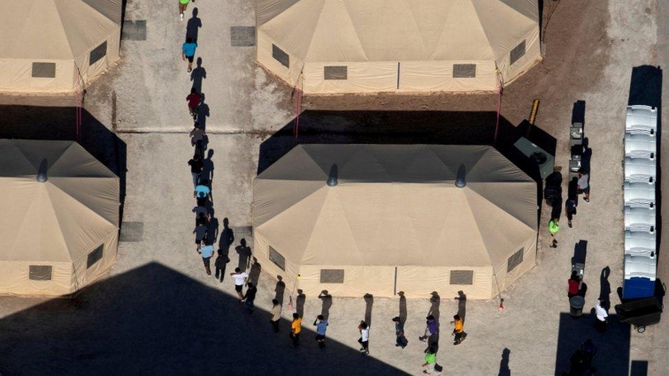 mmigrant children are led by staff in single file between tents at a detention facility next to the Mexican border in Tornillo, Texas, U.S., June 18, 2018.