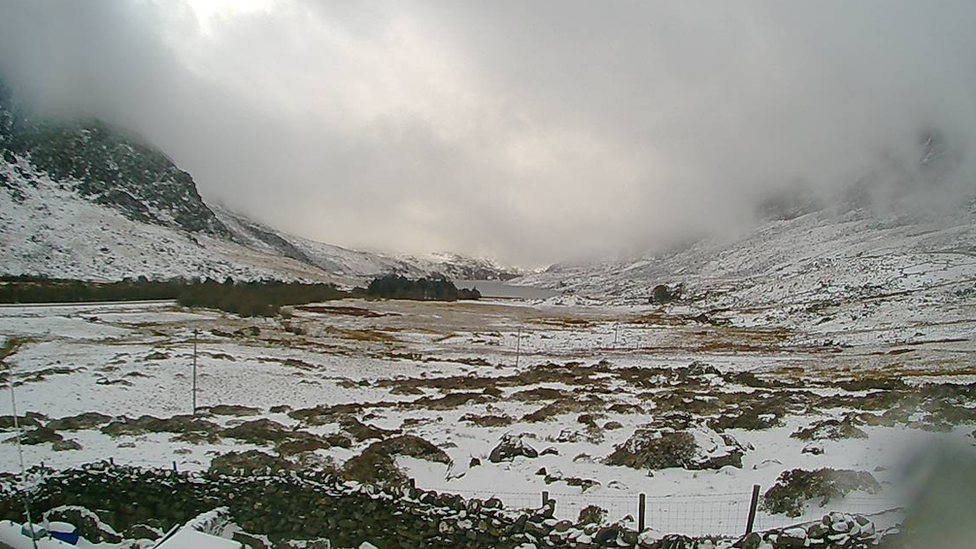 Snow looking across to Tryfan and Y Garn, from Ogwen Mountain Rescue base in Snowdonia, on 6 April, 2021