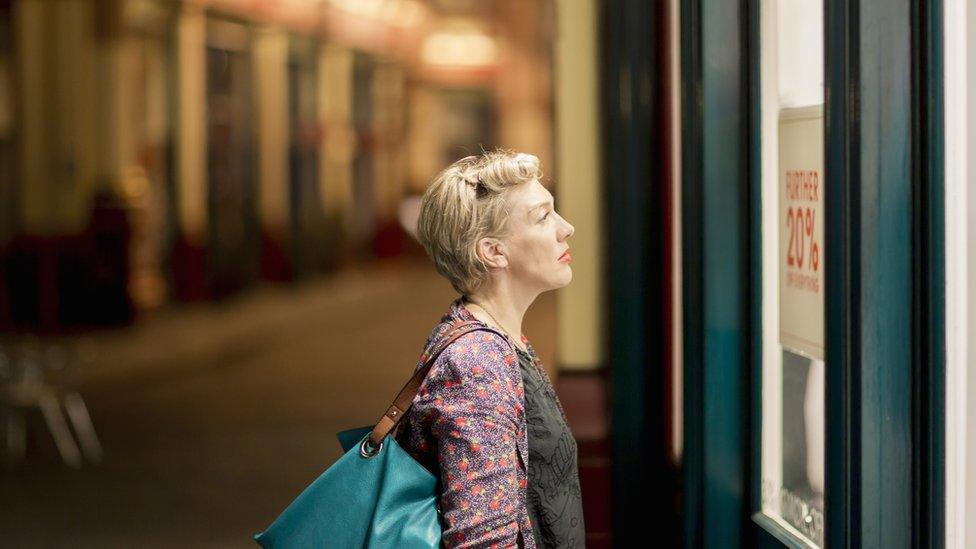 Woman looking in shop window