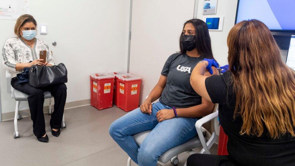 A 16-year old receives a dose of the Pfizer vaccine.