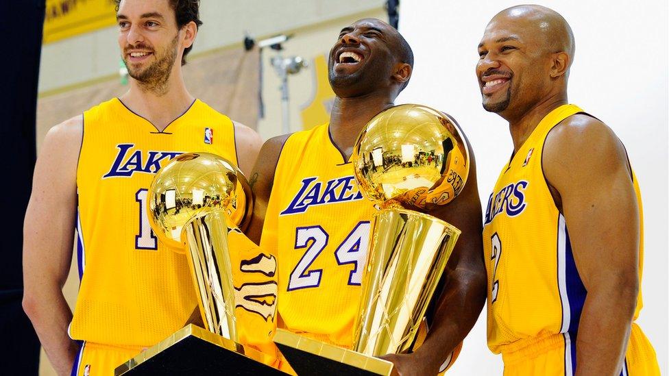 Kobe Bryant and team mates holding their trophies.