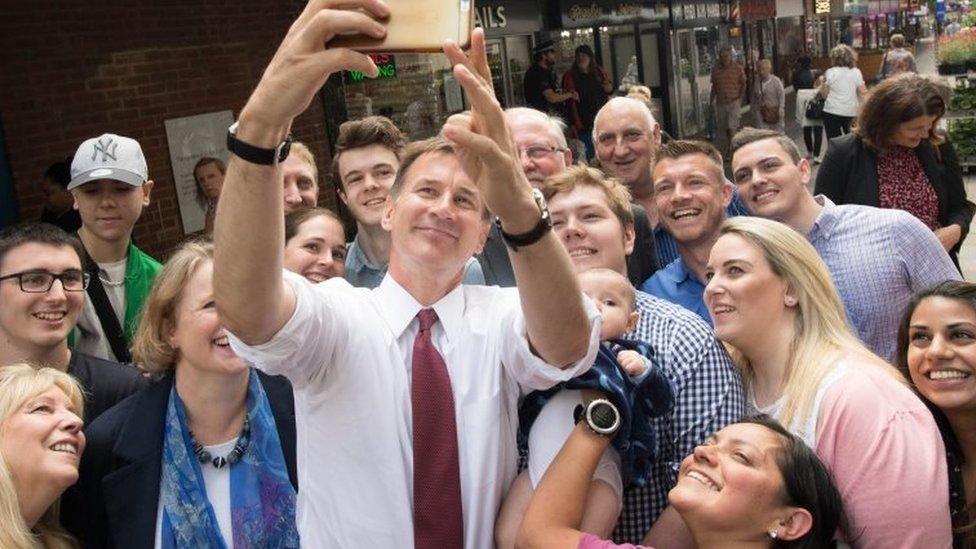 Jeremy Hunt taking a selfie with a crowd of people