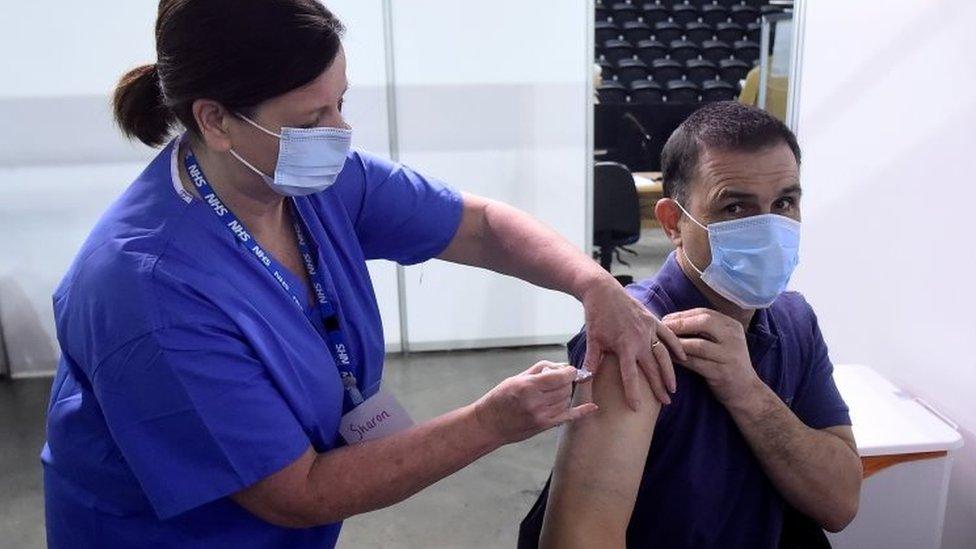 A man receiving a dose of the AstraZeneca vaccine