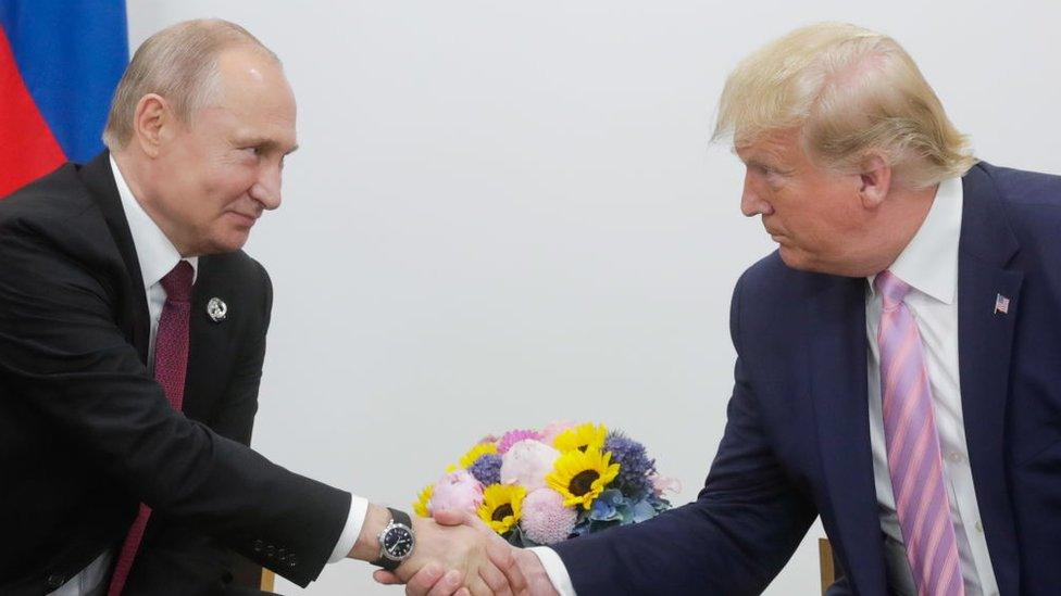 Vladimir Putin and Donald Trump shaking hands at the G20 summit in Osaka in 2019