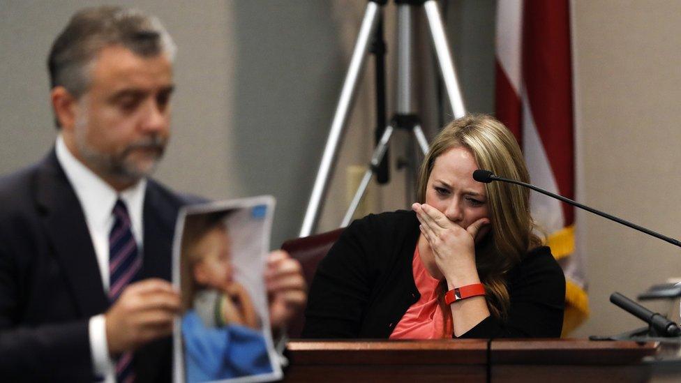 Leanna Taylor cries as defence attorney Maddox Kilgore shows the jury a picture of her son Cooper