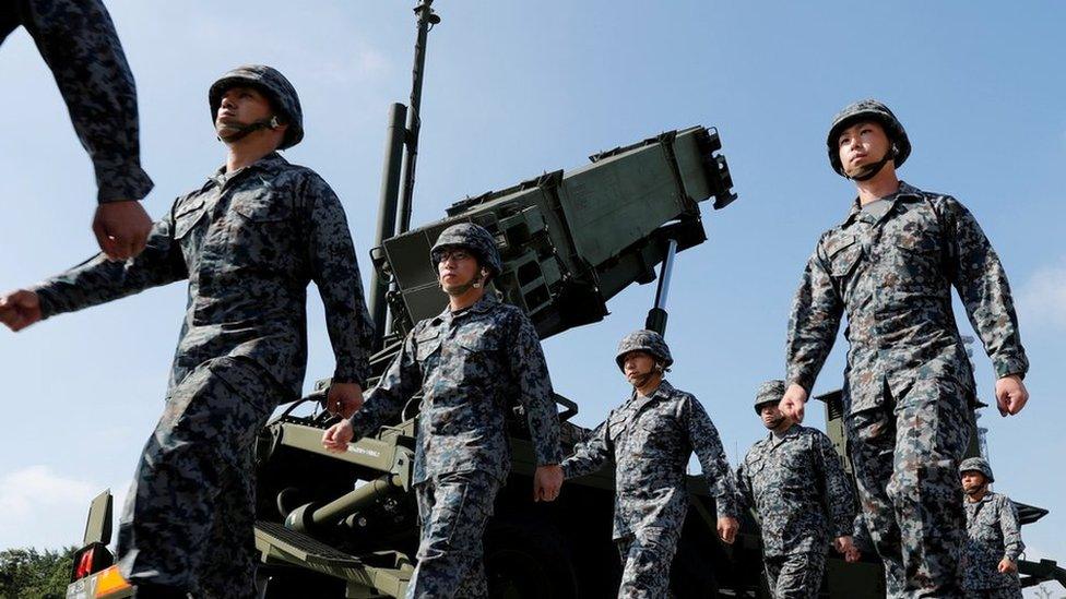 Soldiers from Japan's Self-Defence Force hold a march