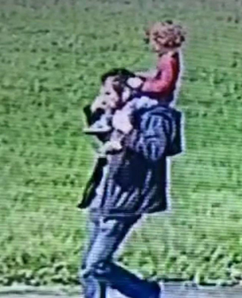 CCTV image of James being carried on his father's shoulders