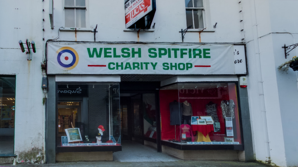 A picture of the store front, occupied by a charity shop