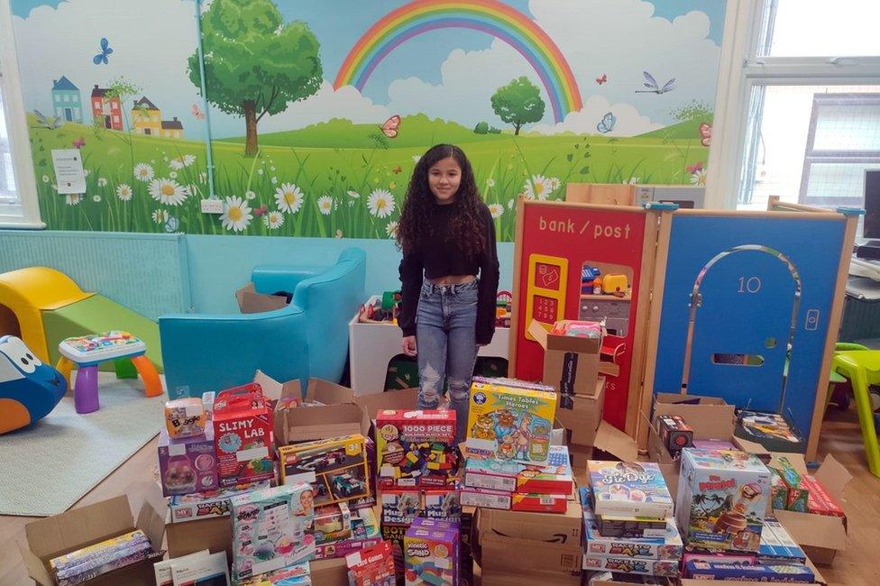 Rhea with the toys that were donated