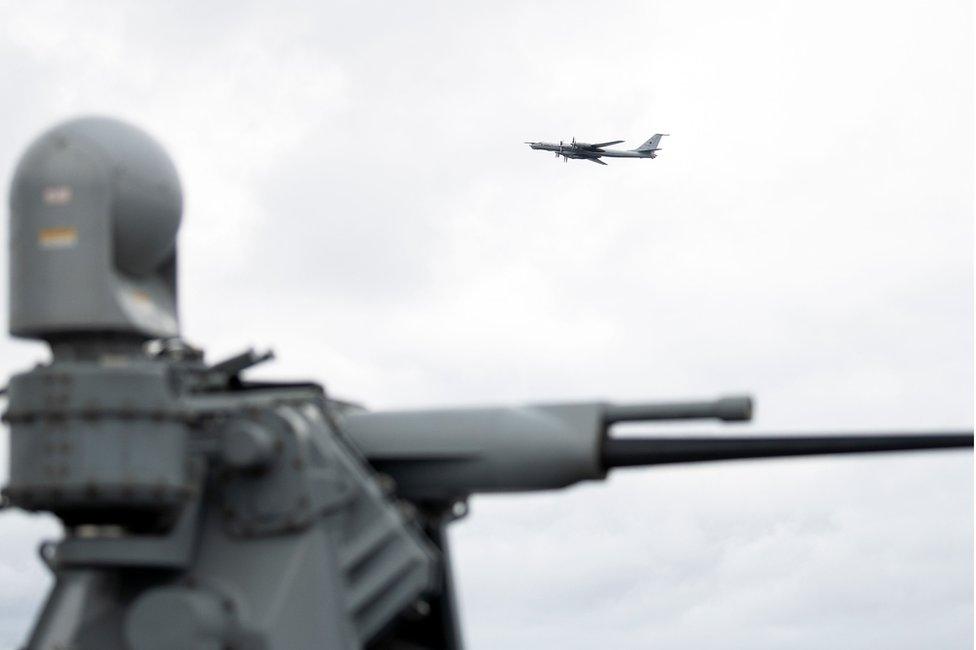 A Russian Tupolev TU-142 flies by the USS Mount Whitney of the US Navy during the NATO-led military exercise Trident Juncture on November 2, 2018 at the Norwegian sea outside Trondheim, Norway