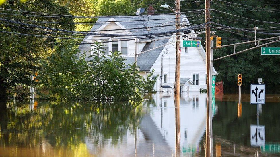 A view of a house surrounded by floodwater in Middlesex after Hurricane Ida