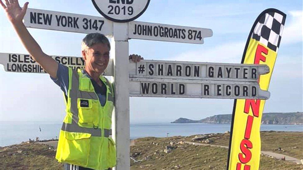 Sharon Gayter under the Land's End location sign