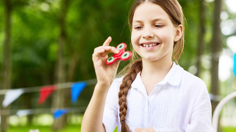 Girl playing with fidget spinner