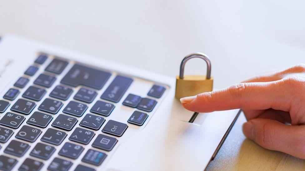 A photo of a laptop and a padlock