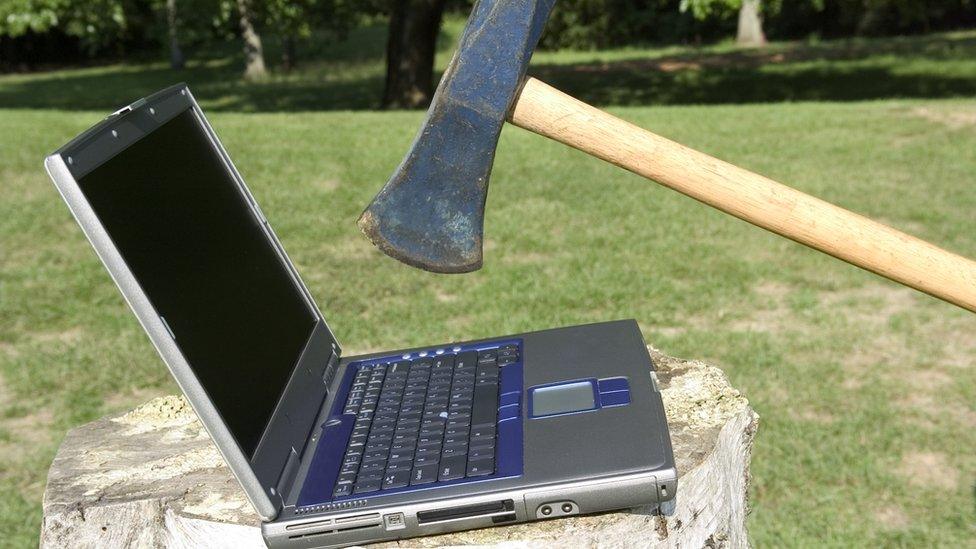 Axe coming down on laptop