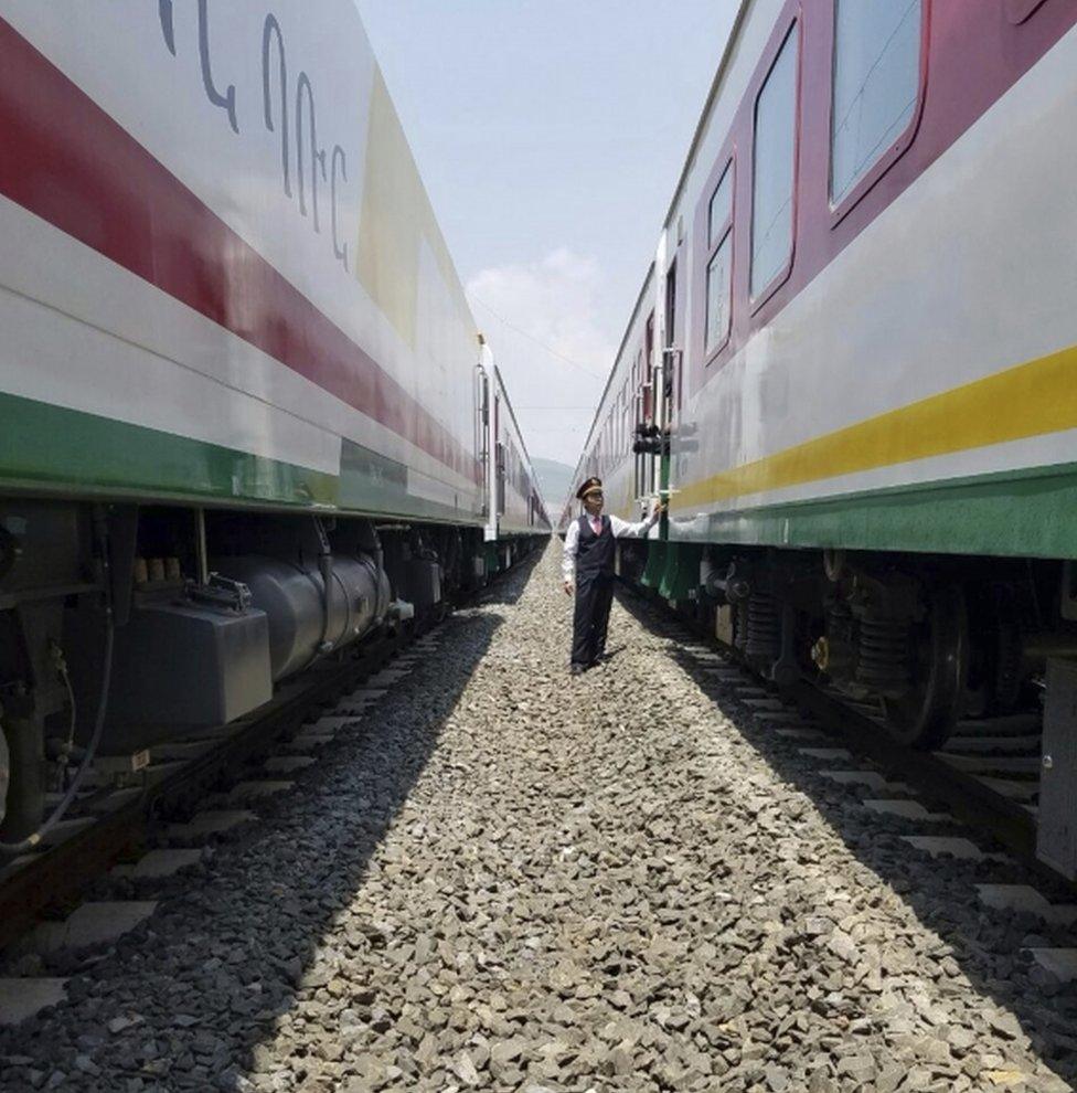 Chinese Chinese attendant inspects as reporters board the new Addis Ababa to Djibouti railway system