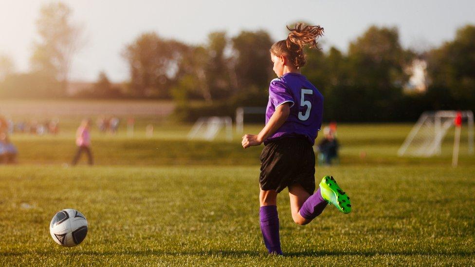 Girl playing football