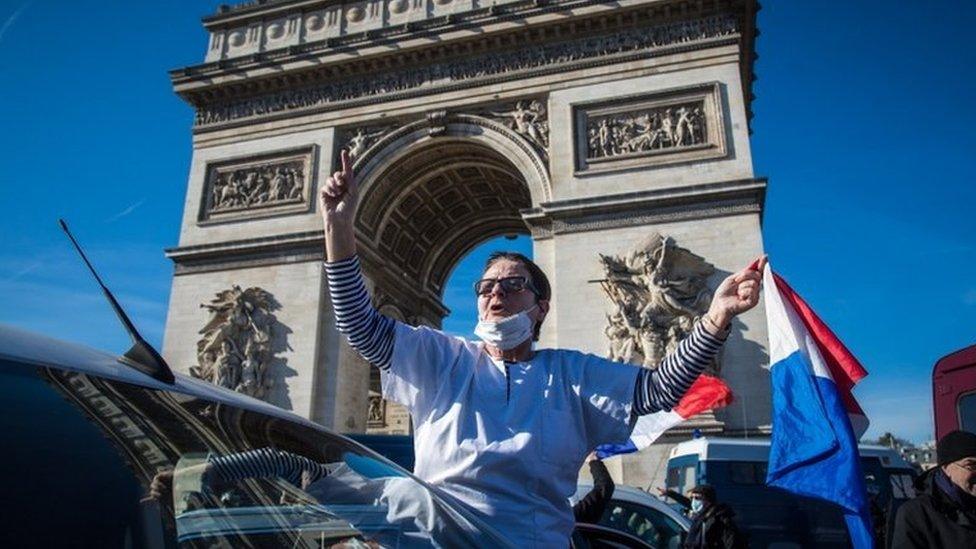 A protester by the Arc de Triomphe