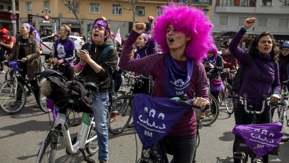 Women wear purple as they take part in a feminist bicycle protest during International Women's Day in Madrid, Spain, 8 March 2020