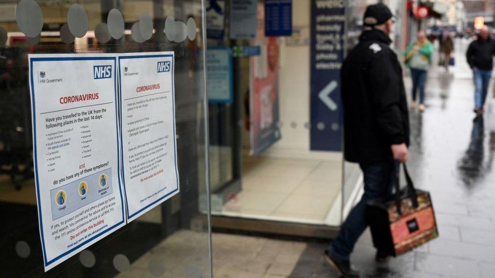 Man leaving pharmacy with bag