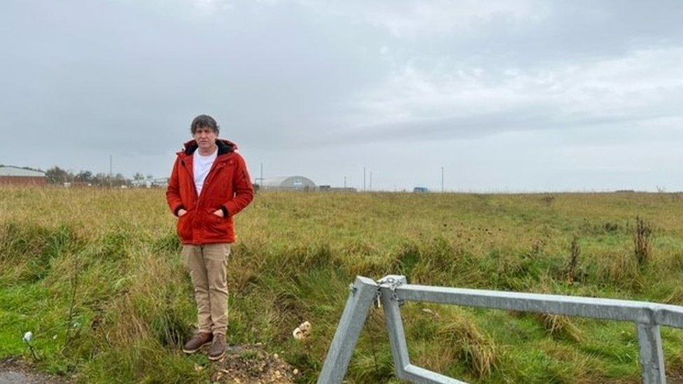 Pip Fallow standing on waste ground in East Durham