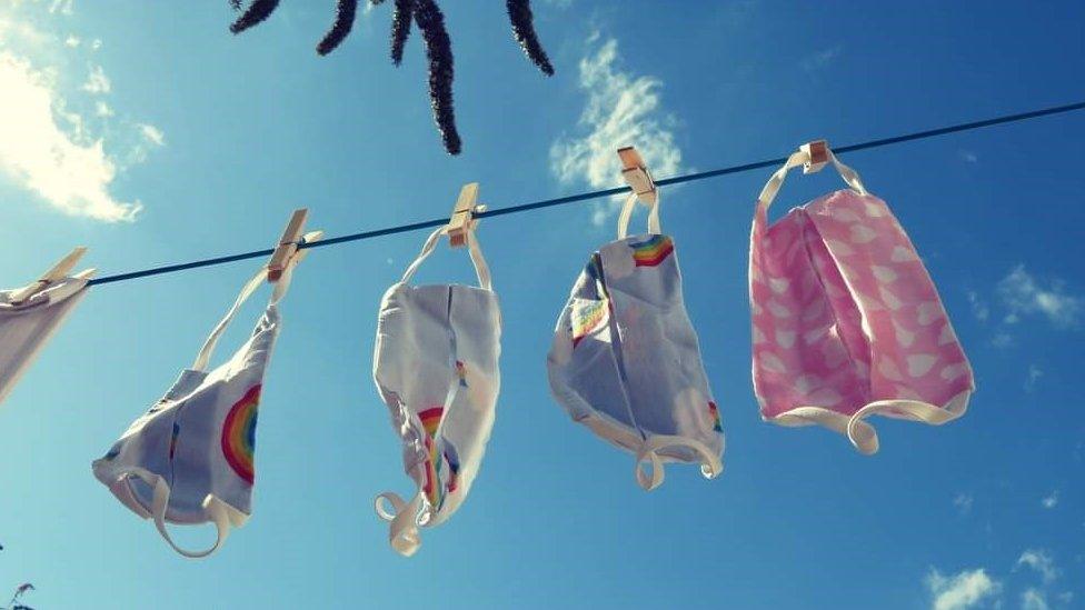 Face masks on washing line, with background of blue sky