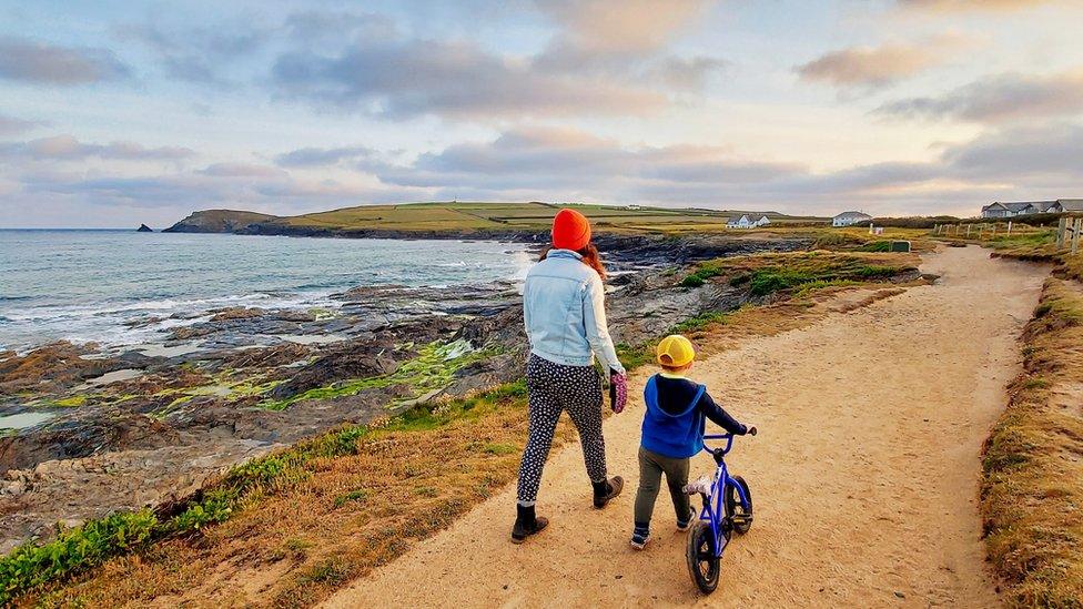 Mother and son walking by sea