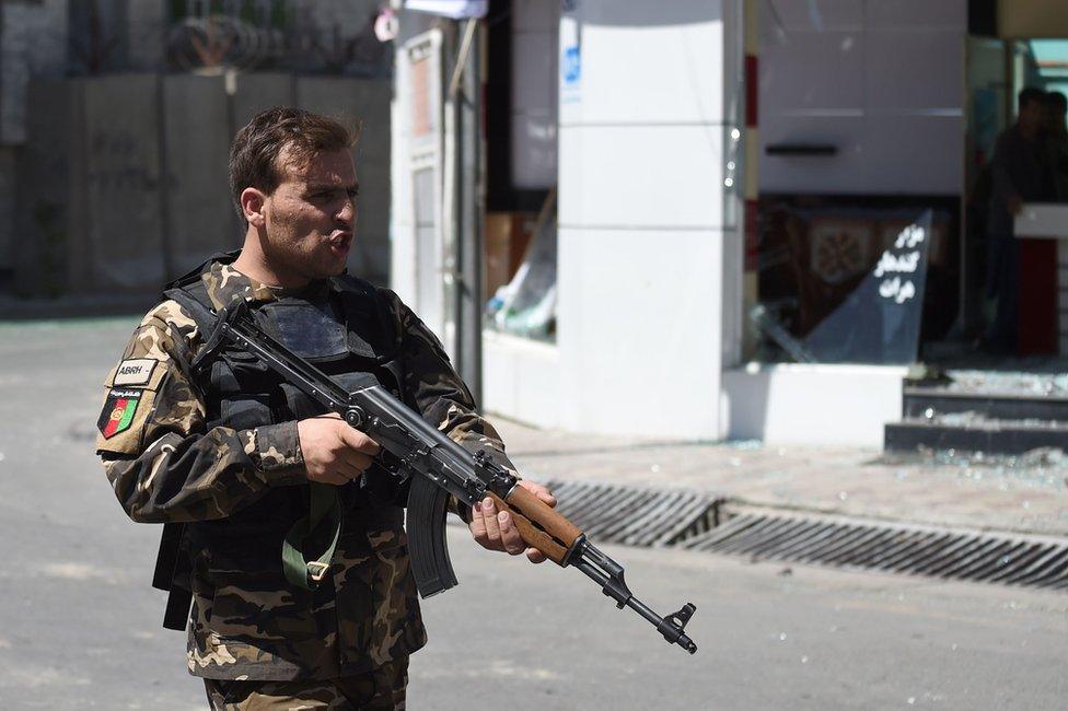 An Afghan security personnel stands guard near the site of a truck bomb attack in Kabul on 31 May 2017