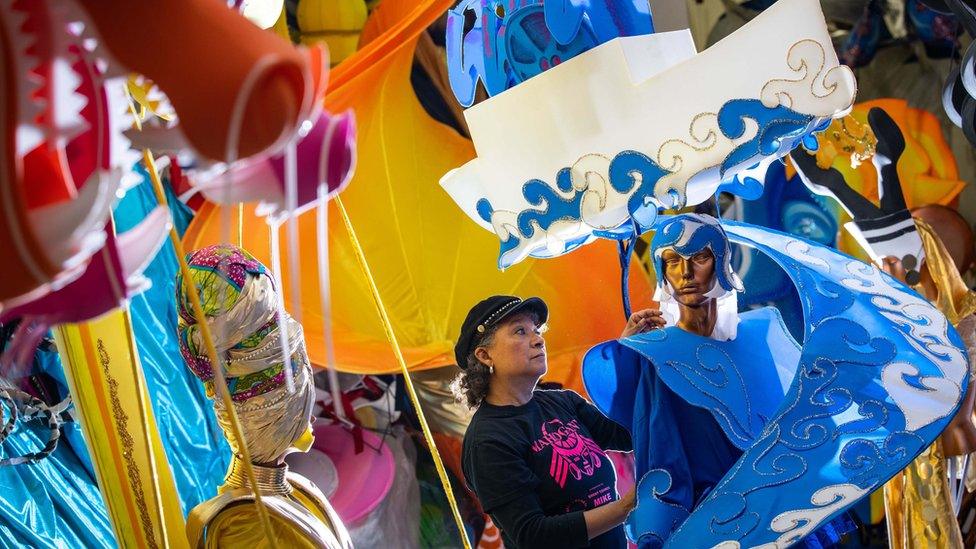 Clary Salandy adjusts a costume for the first Notting Hill virtual carnival at her shop in Harlesden, North London.