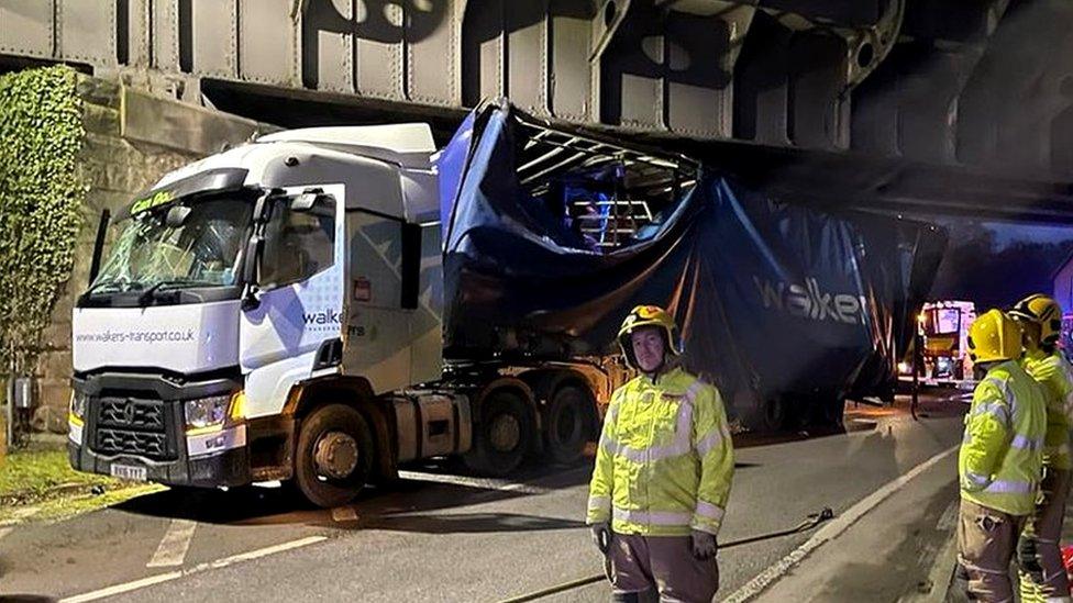 Officers with lorry under bridge