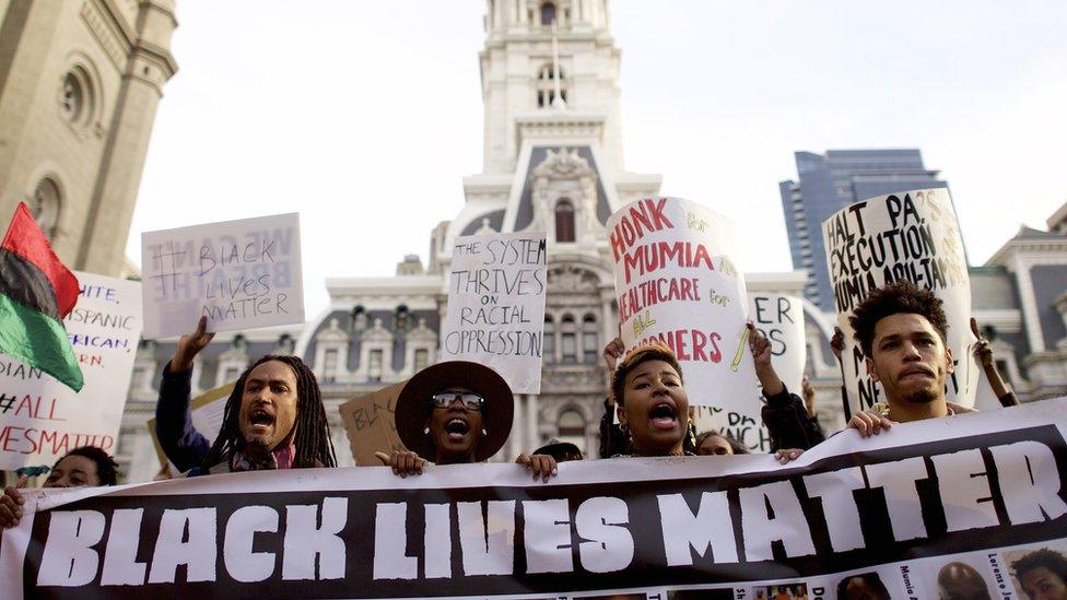 Protesters march past City Hall during a demonstration over the death of Freddy Gray outside City Hall on 30 April in Philadelphia, Pennsylvania.