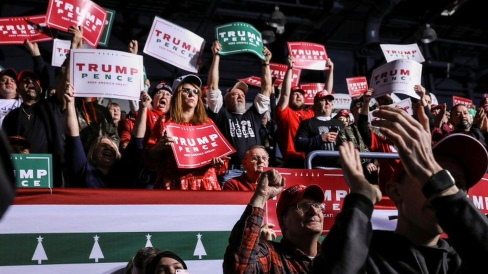 Supporters react while attending US President Donald Trump's campaign rally in Battle Creek, Michigan