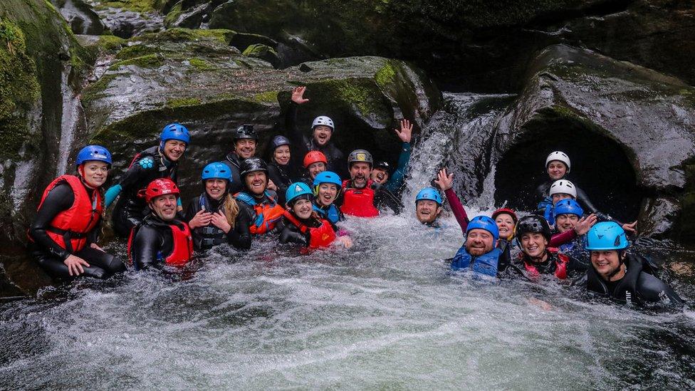 A group of gorge walkers in a Manx river