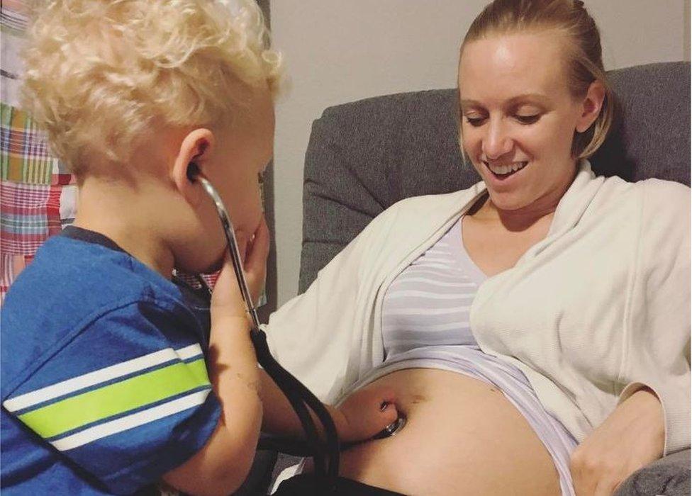 Swimmer Dana Vollmer with son Arlen holding a stethascope - March 2017