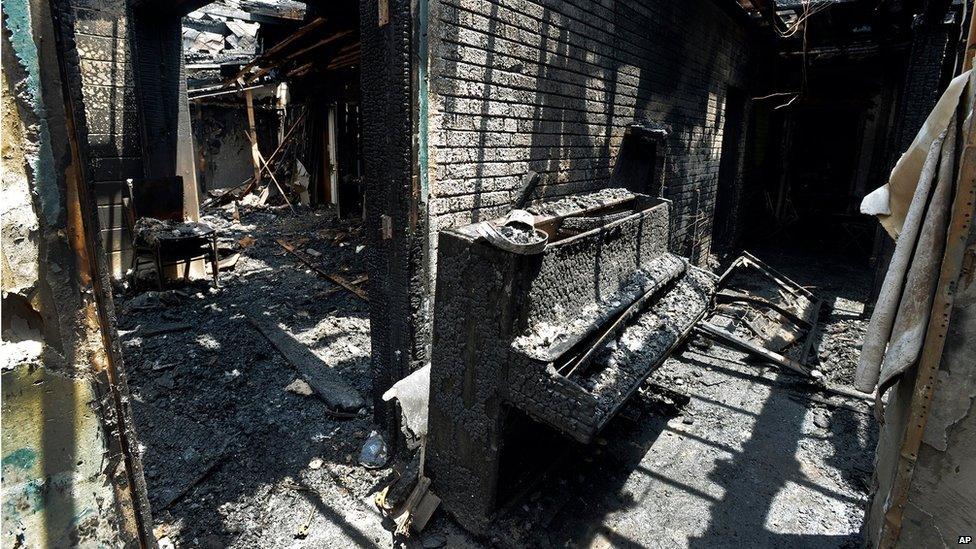 A destroyed piano is part of the charred remains of Briar Creek Road Baptist Church on 24 June 24 in Charlotte, North Carolina.