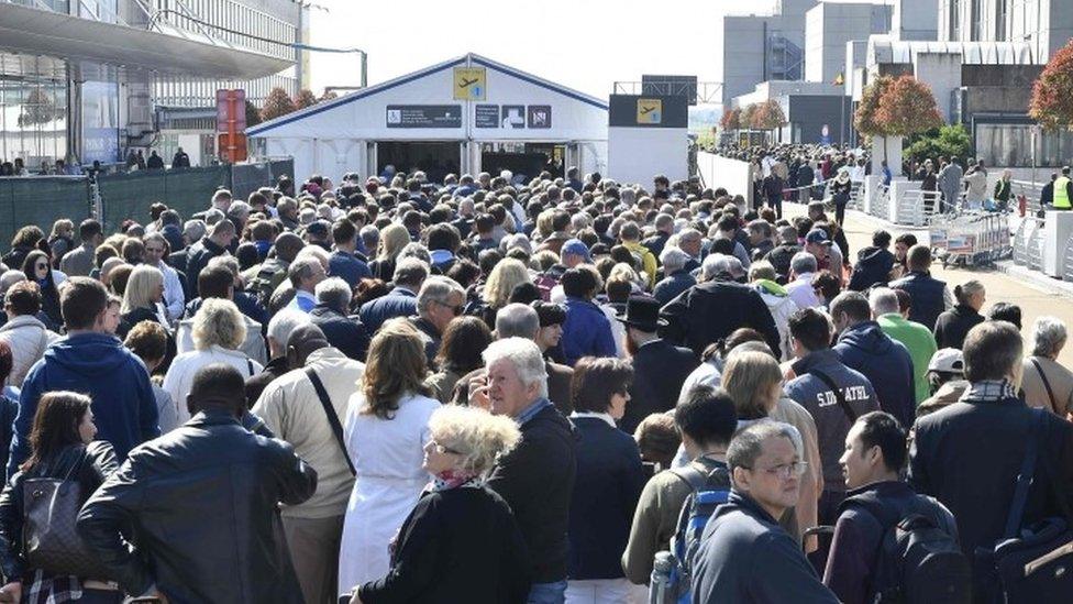 People queue outside the departure hall at Brussels airport